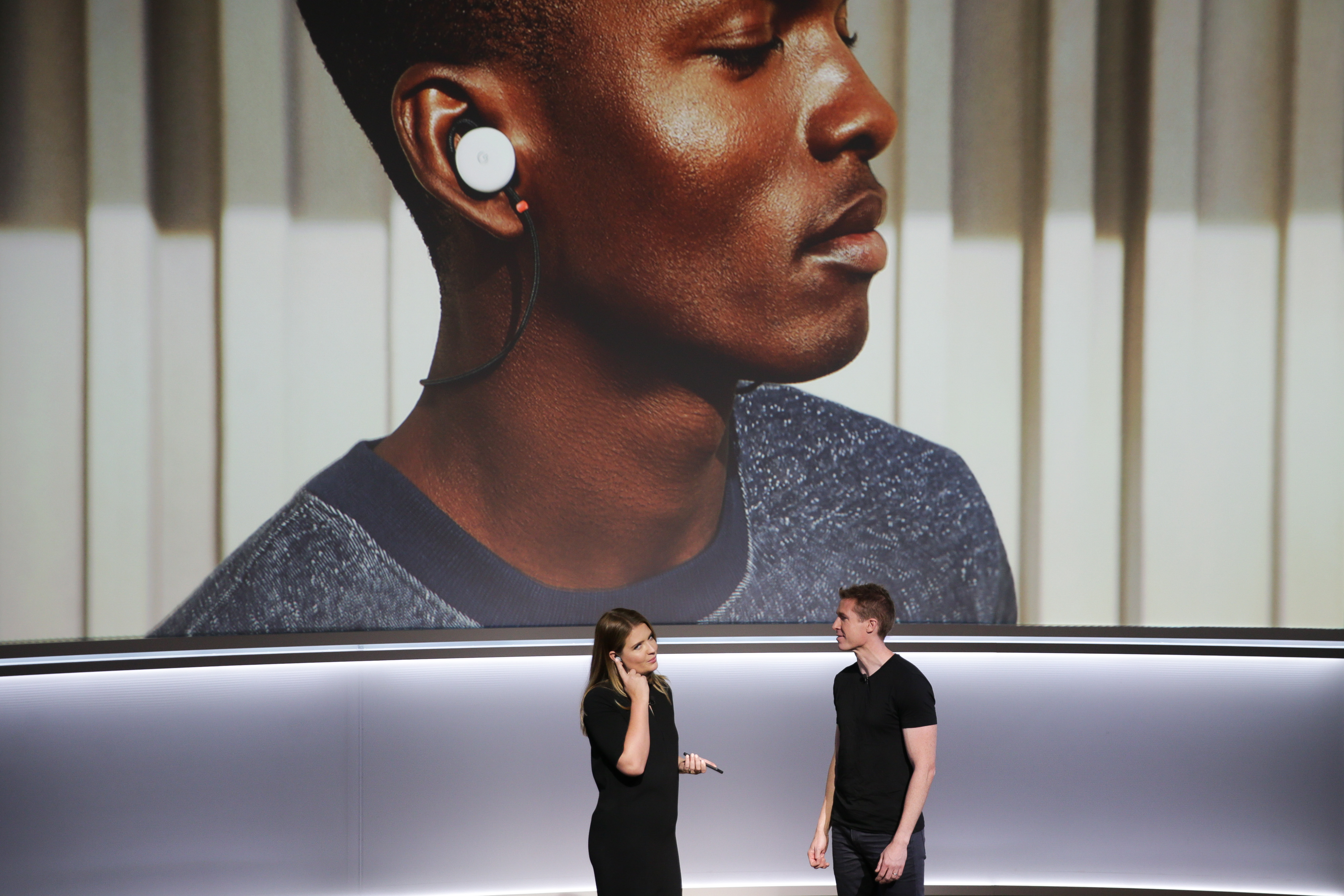 Isabelle Olsson, lead designer for home hardware for Google, and Juston Payne, Product Manager for Google Clips, demonstrate two-way translation using Google Pixel Buds and the Google Pixel 2 smartphone at a product launch event on October 4, 2017 at the SFJAZZ Center in San Francisco, California. (Photo: ELIJAH NOUVELAGE/AFP/Getty Images)