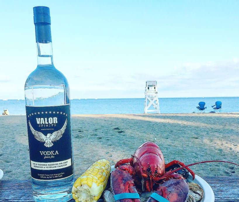 Valor and a lobster hanging out together at the beach. Photo: courtesy of Valor Spirits.
