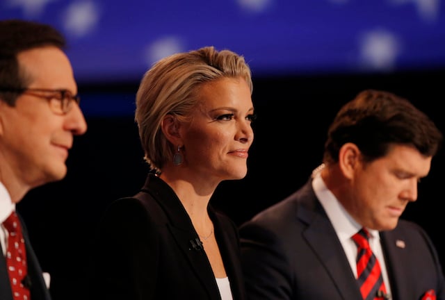 Fox News Channel anchor Megyn Kelly sits between fellow debate moderators Chris Wallace (L) and Bret Baier during the debate held by Fox News for the top 2016 U.S. Republican presidential candidates in Des Moines, Iowa January 28, 2015. REUTERS/Carlos Barria - TB3EC1T07NGV9