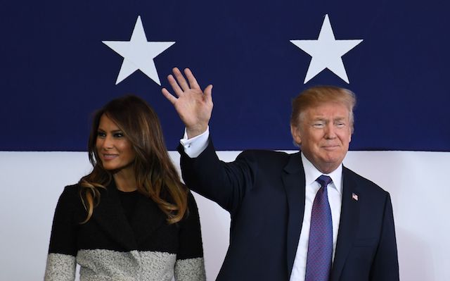 US President Donald Trump (R) waves as First Lady Melania smiles upon arriving at US Yokota Air Base in Tokyo on November 5, 2017. Trump touched down in Japan, kicking off the first leg of a high-stakes Asia tour set to be dominated by soaring tensions with nuclear-armed North Korea. / AFP PHOTO / Toshifumi KITAMURA / The erroneous mention[s] appearing in the metadata of this photo by Toshifumi KITAMURA has been modified in AFP systems in the following manner: [November 5] instead of [November 4]. Please immediately remove the erroneous mention[s] from all your online services and delete it (them) from your servers. If you have been authorized by AFP to distribute it (them) to third parties, please ensure that the same actions are carried out by them. Failure to promptly comply with these instructions will entail liability on your part for any continued or post notification usage. Therefore we thank you very much for all your attention and prompt action. We are sorry for the inconvenience this notification may cause and remain at your disposal for any further information you may require. (Photo credit should read TOSHIFUMI KITAMURA/AFP/Getty Images)