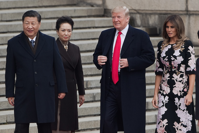 US President Donald Trump (C), First Lady Melania Trump (R), China's President Xi Jinping (L) and his wife Peng Liyuan (2nd L) attend a welcome ceremony at the Great Hall of the People in Beijing on November 9, 2017. / AFP PHOTO / NICOLAS ASFOURI (Photo credit should read NICOLAS ASFOURI/AFP/Getty Images)