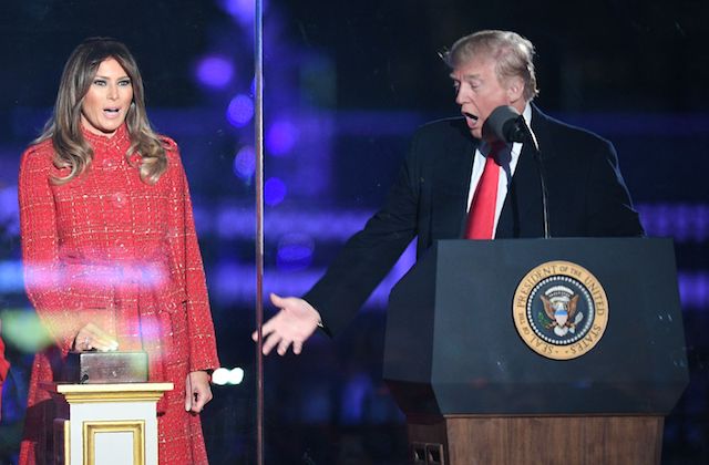 US President Donald Trump (R) gestures as First lady Melania Trump smiles during the 95th annual National Christmas Tree Lighting ceremony at the Ellipse in President's Park near the White House in Washington, DC on November 30, 2017. / AFP PHOTO / JIM WATSON (Photo credit should read JIM WATSON/AFP/Getty Images)