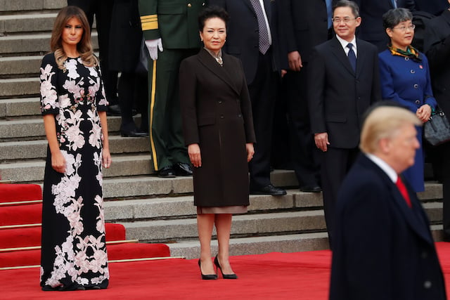 U.S. first lady Melania Trump and China's First Lady Peng Liyuan watch as U.S. President Donald Trump takes part in a welcoming ceremony with China's President Xi Jinping in Beijing, China, November 9, 2017. REUTERS/Damir Sagolj - RC15832548C0
