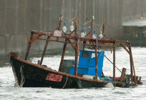 A wooden boat, which according to a police official carried eight men who said they were from North Korea and appear to be fishermen whose vessel ran into trouble, is seen near a breakwater in Yurihonjo, Akita Prefecture, Japan, November 24, 2017. Mandatory credit Kyodo/via REUTERS 