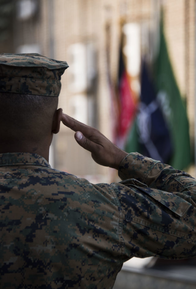 A Marine salutes while the national anthem is played during a ceremony commemorating the U.S. Marine Corps 242nd birthday at Resolute Support Headquarters in Kabul, Afghanistan. (Hailey Sadler)