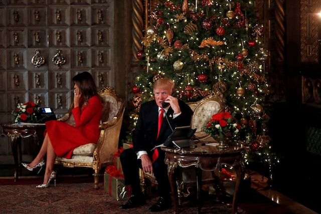 U.S. President Donald Trump and First Lady Melania Trump participate in NORAD (North American Aerospace Defense Command) Santa Tracker phone calls with children at Mar-a-Lago estate in Palm Beach, Florida, U.S., December 24, 2017. REUTERS/Carlos Barria TPX IMAGES OF THE DAY - RC139CE8FF80