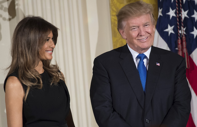 US President Donald Trump and First Lady Melania Trump attend a Hanukkah reception in the East Room of the White House in Washington, DC, December 7, 2017. / AFP PHOTO / SAUL LOEB