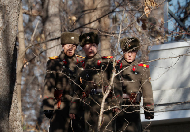 A North Korean soldier keeps watch toward the south in front of their guard post just next to a spot where a North Korean has defected crossing the border on November 13, at the truce village of Panmunjom inside the demilitarized zone, South Korea, November 27, 2017. REUTERS/Kim Hong-Ji