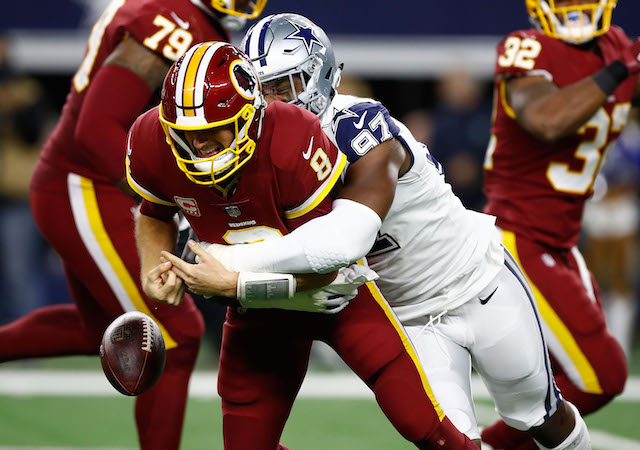 ARLINGTON, TX - NOVEMBER 30: Kirk Cousins #8 of the Washington Redskins fumbles the ball after a hit by Taco Charlton #97 of the Dallas Cowboys in the second quarter of a football game at AT&T Stadium on November 30, 2017 in Arlington, Texas. (Photo by Wesley Hitt/Getty Images)