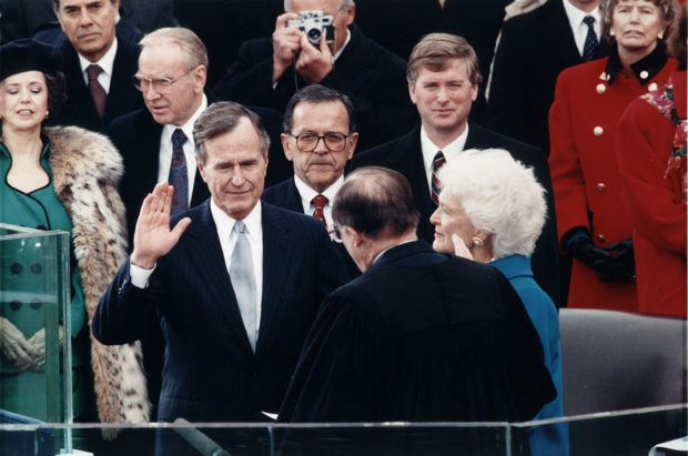 Chief Justice William Rehnquist administering the oath of office to President George H. W. Bush during Inaugural ceremonies at the United States Capitol via Wikimedia Commons