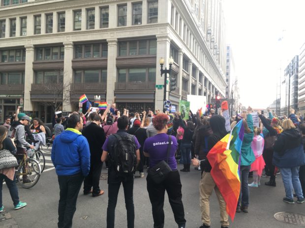 Protesters dress in rainbow colors and hold up rainbow flags for the LGBT community (The Daily Caller/Julia Nista)