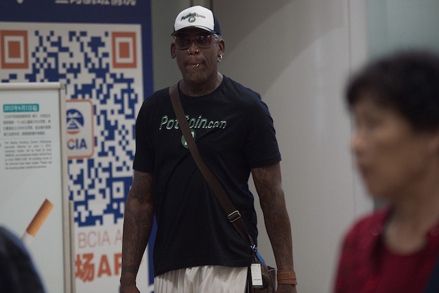 Former NBA basketball player Dennis Rodman (C) of the US walks out from the arrival gate returning from his trip to North Korea at Beijing's international airport on June 17, 2017. / AFP PHOTO / NICOLAS ASFOURI (Photo credit should read NICOLAS ASFOURI/AFP/Getty Images)