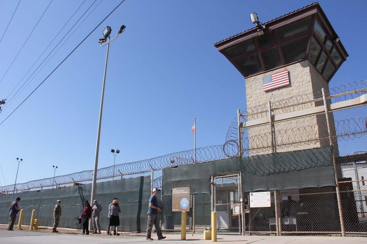 Poeple walk past a guard tower outside the fencing of Camp 5 at the US Military's Prison in Guantanamo Bay, Cuba on January 26, 2017. President Donald Trump has said he "absolutely" thinks torture works, but doctors, lawyers for terror suspects, and even fellow Republicans have pledged to oppose any effort to reinstate waterboarding or other banned interrogation techniques. / AFP / Thomas WATKINS (Photo credit should read THOMAS WATKINS/AFP/Getty Images)