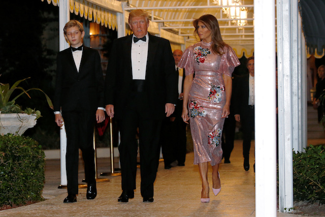 U.S. President Donald Trump and first lady Melania Trump, with their son Barron, arrive for a New Year's Eve party at his Mar-a-Lago club in Palm Beach, Florida, U.S. December 31, 2017. REUTERS/Jonathan Ernst - RC1E5CB0BC10