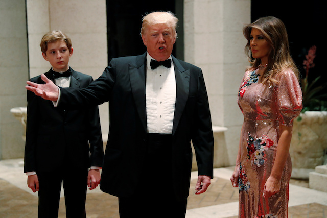 U.S. President Donald Trump and first lady Melania Trump, with their son Barron, arrive for a New Year's Eve party at his Mar-a-Lago club in Palm Beach, Florida, U.S. December 31, 2017. REUTERS/Jonathan Ernst - RC1699A89940
