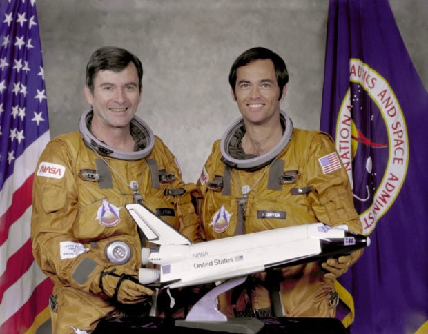 STS-1 crew members Commander John Young (L) and Pilot Robert Crippen pose with a model of the Space Shuttle Columbia at Johnson Space Center in Houston May, 7, 1979. Young and Crippen flew the first orbital mission of NASA's space shuttle program aboard the Columbia. REUTERS/NASA/Handout