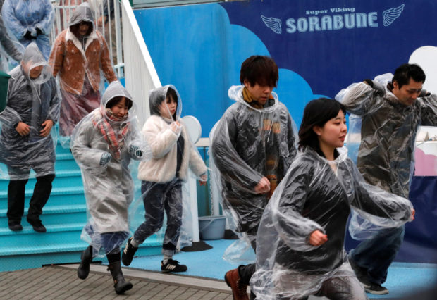 Participants run during an anti-missile evacuation drill at the Tokyo Dome City amusement park in Tokyo, Japan January 22, 2018. REUTERS/Kim Kyung-Hoon