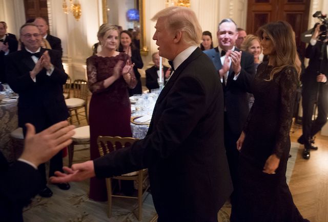 US President Donald Trump and First Lady Melania Trump arrive for the Governors Ball for US governors attending the National Governors Association (NGA) winter meeting in the State Dining Room of the White House in Washington, DC, February 25, 2018. / AFP PHOTO / SAUL LOEB (Photo credit should read SAUL LOEB/AFP/Getty Images)