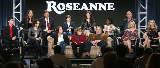 PASADENA, CA - JANUARY 08: (L-R, Back Row) Executive producers Whitney Cummings and Tom Werner, actors Ames McNamera, Emma Kenney, Jayden Rey, executive producer Bruce Helford, (l-r, front row) actor Michael Fishman, executive producer/actress Sara Gilbert, actress Laurie Metcalf, executive producer/actress Roseanne Barr, actors John Goodman, Lecy Goranson and Sarah Chalke of the television show Roseanne speak onstage during the ABC Television/Disney portion of the 2018 Winter Television Critics Association Press Tour at The Langham Huntington, Pasadena on January 8, 2018 in Pasadena, California. (Photo by Frederick M. Brown/Getty Images)