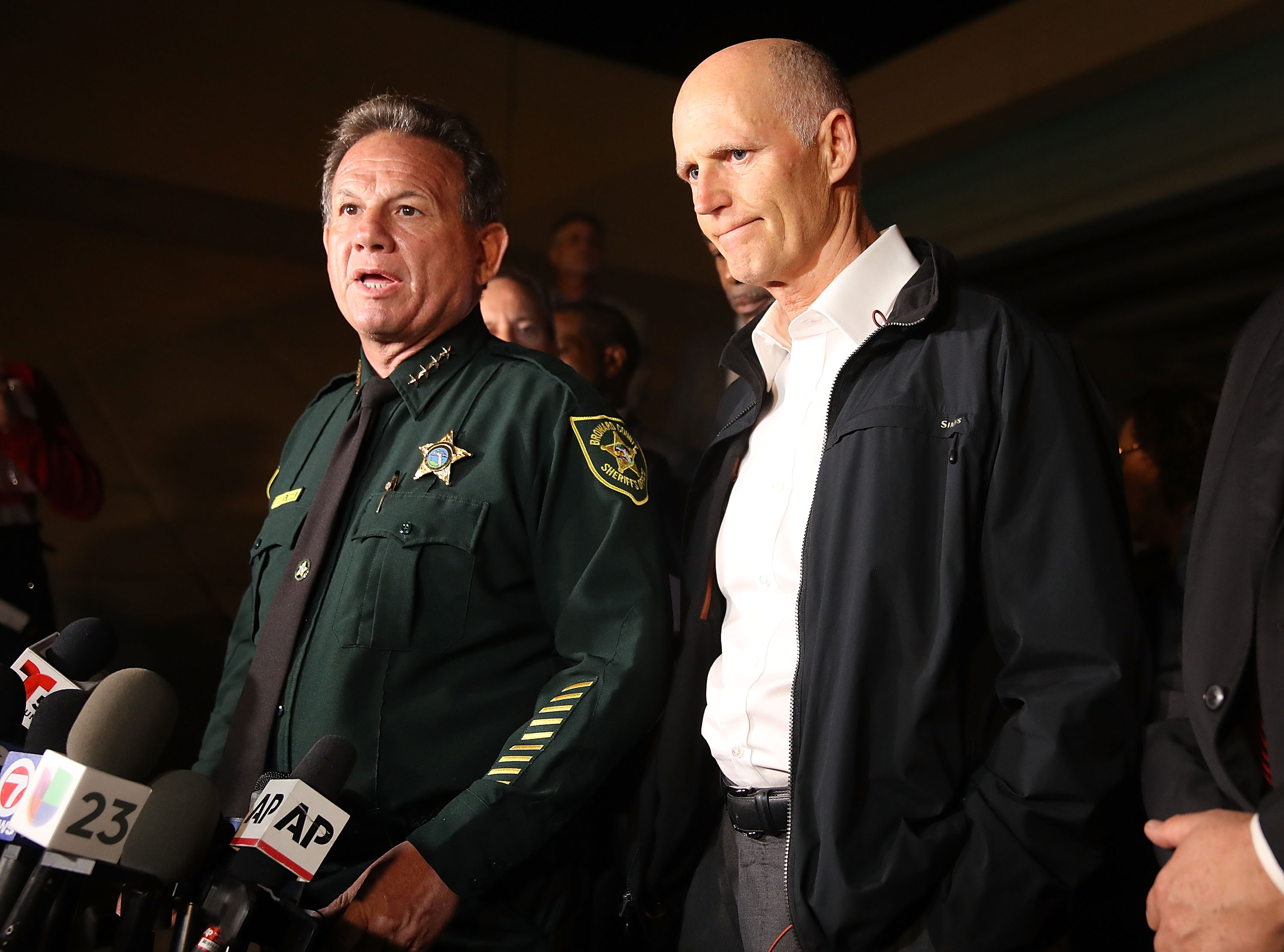 PARKLAND, FL - FEBRUARY 14: Scott Israel, Sheriff of Broward County, (L) and Florida Governor Rick Scott speak to the media as they visit Marjory Stoneman Douglas High School after a shooting at the school killed 17 people on February 14, 2018 in Parkland, Florida. Numerous law enforcement officials continue to investigate the scene. (Photo by Joe Raedle/Getty Images)