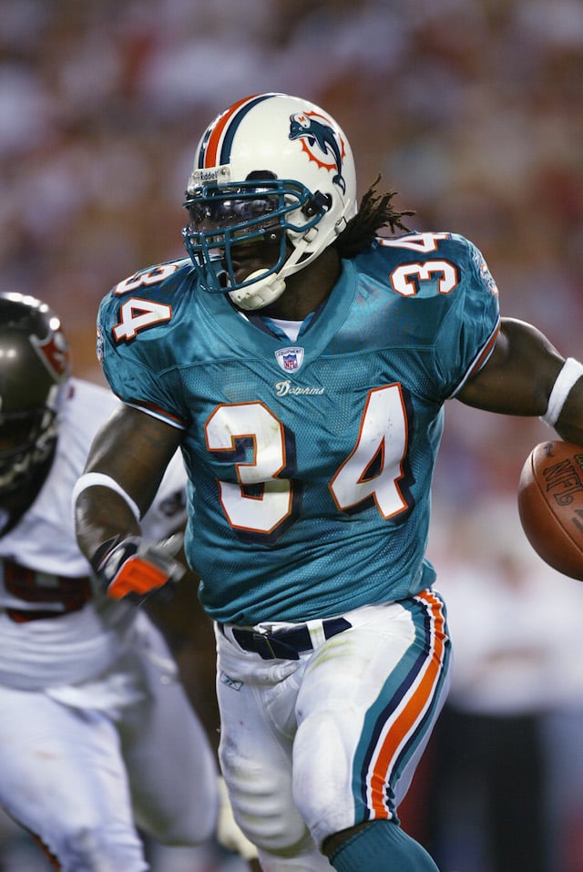 TAMPA, FL - AUGUST 12: Running Back Ricky Williams #34 of the Miami Dolphins runs for short yardage against the Tampa Bay Buccaneers in the first half on August 12, 2002 at Raymond James Stadium in Tampa, Florida. The Buccaneers defeated the Dolphins 14-10. (Photo By Eliot Schechter/Getty Images)