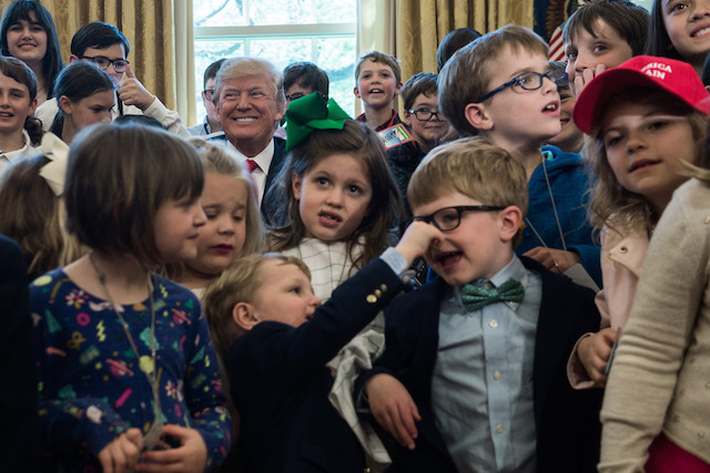 US President Donald Trump poses with children of press and staff during the "Take your Daughters and Sons to Work" day in the Oval Office at the White House in Washington, DC, on April 26, 2018. (Photo by NICHOLAS KAMM / AFP) (Photo credit should read NICHOLAS KAMM/AFP/Getty Images)