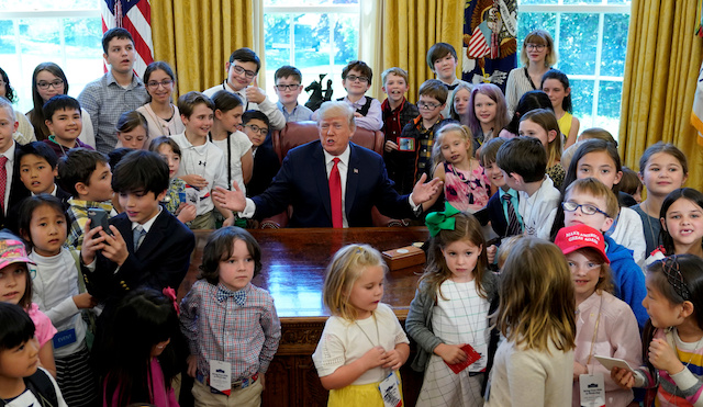 U.S. President Donald Trump poses with children of staff and press in the Oval Office of the White House on "take your child to work day" in Washington. U.S., April 26, 2018. REUTERS/Kevin Lamarque TPX IMAGES OF THE DAY - RC1B159C8090