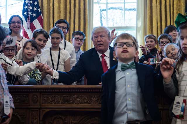 US President Donald Trump poses with children of press and staff during "Take your Daughters and Sons to Work Day" in the Oval Office at the White House in Washington, DC, on April 26, 2018. (Photo by NICHOLAS KAMM / AFP) (Photo credit should read NICHOLAS KAMM/AFP/Getty Images)