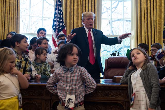 US President Donald Trump poses with children of press and staff during "Take your Daughters and Sons to Work Day" in the Oval Office at the White House in Washington, DC, on April 26, 2018. (Photo by NICHOLAS KAMM / AFP) (Photo credit should read NICHOLAS KAMM/AFP/Getty Images)