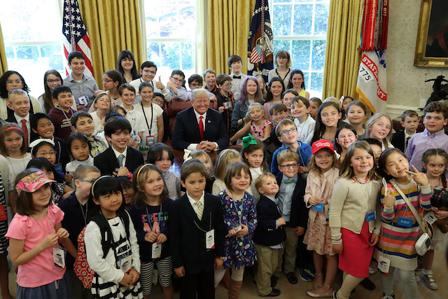 WASHINGTON, DC - APRIL 26: U.S. President Donald Trump is surrounded by the children of members of the media and White House staff during Take Your Child To Work Day in the Oval Office on April 26, 2018 in Washington, DC. (Photo by Mark Wilson/Getty Images)