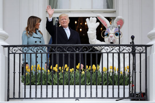 WASHINGTON, DC - APRIL 02: (AFP OUT) U.S. President Donald Trump (C) and first lady Melania Trump (L) walk out onto the Truman Balcony with a person in an Easter Bunny costume during the 140th annual Easter Egg Roll on the South Lawn of the White House April 2, 2018 in Washington, DC. The White House said they are expecting 30,000 children and adults to participate in the annual tradition of rolling colored eggs down the White House lawn that was started by President Rutherford B. Hayes in 1878. (Photo by Chip Somodevilla/Getty Images)