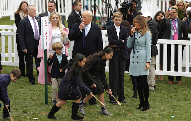 President Donald Trump and first lady Melania Trump blow whistles for children gathered for the annual White House Easter Egg Roll as they stand with his daughter Tiffany and their son Barron on the South Lawn of the White House in Washington, U.S., April 2, 2018. REUTERS/Carlos Barria - HP1EE4216PZQQ