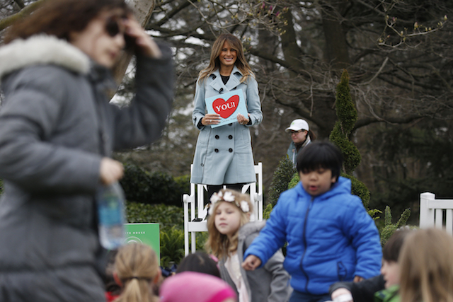Children and U.S. first lady Melania Trump stand up after she read Sandra Boynton's book "You!" to children gathered for the annual White House Easter Egg Roll on the South Lawn of the White House in Washington, U.S., April 2, 2018. REUTERS/Leah Millis - HP1EE421710R0