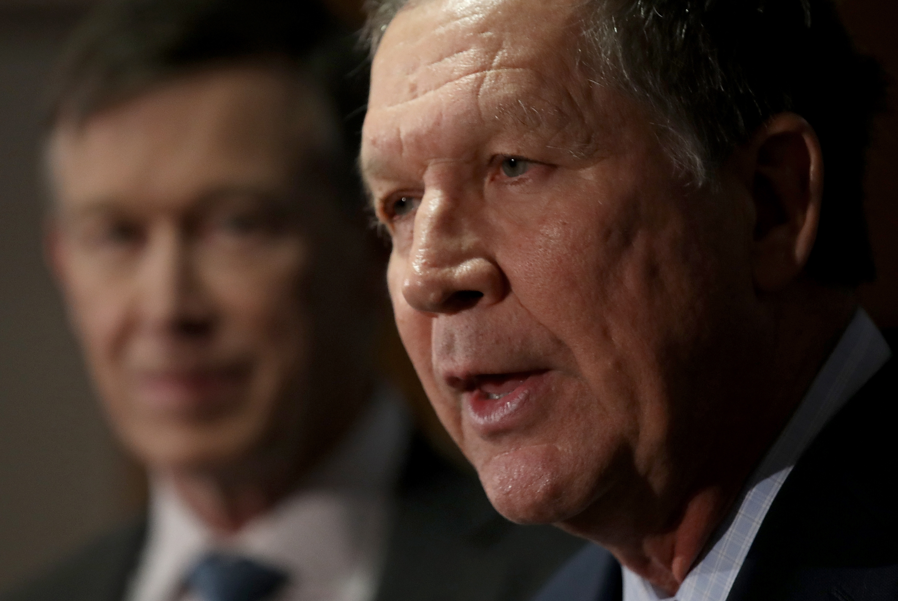 WASHINGTON, DC - FEBRUARY 23: Gov. John Kasich (R) (R-OH) speaks as Gov. John Hickenlooper (L) (D-CO) listens during a press conference February 23, 2018 in Washington, DC. The three governors unveiled a blueprint for improved health care in the U.S. during the press conference. (Photo by Win McNamee/Getty Images)