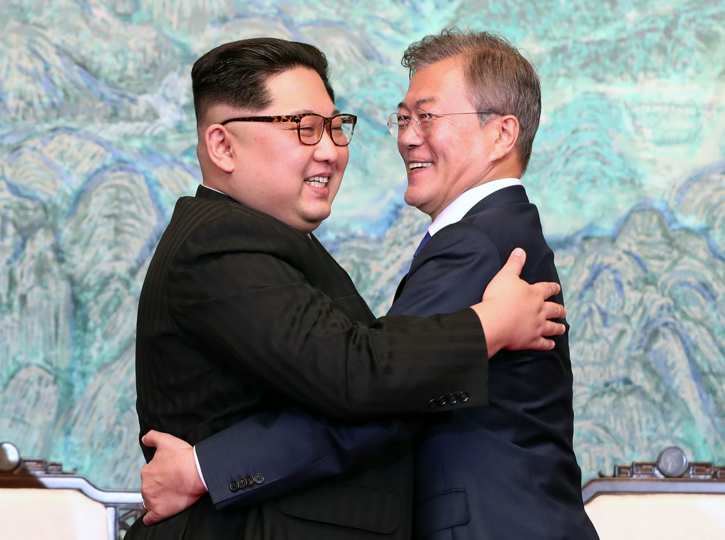 PANMUNJOM, SOUTH KOREA - APRIL 27: North Korean leader Kim Jong Un (L) and South Korean President Moon Jae-in (R) embrace after signing the Panmunjom Declaration for Peace, Prosperity and Unification of the Korean Peninsula during the Inter-Korean Summit at the Peace House on April 27, 2018 in Panmunjom, South Korea. Kim and Moon meet at the border today for the third-ever Inter-Korean summit talks after the 1945 division of the peninsula, and first since 2007 between then President Roh Moo-hyun of South Korea and Leader Kim Jong-il of North Korea. (Photo by Korea Summit Press Pool/Getty Images)