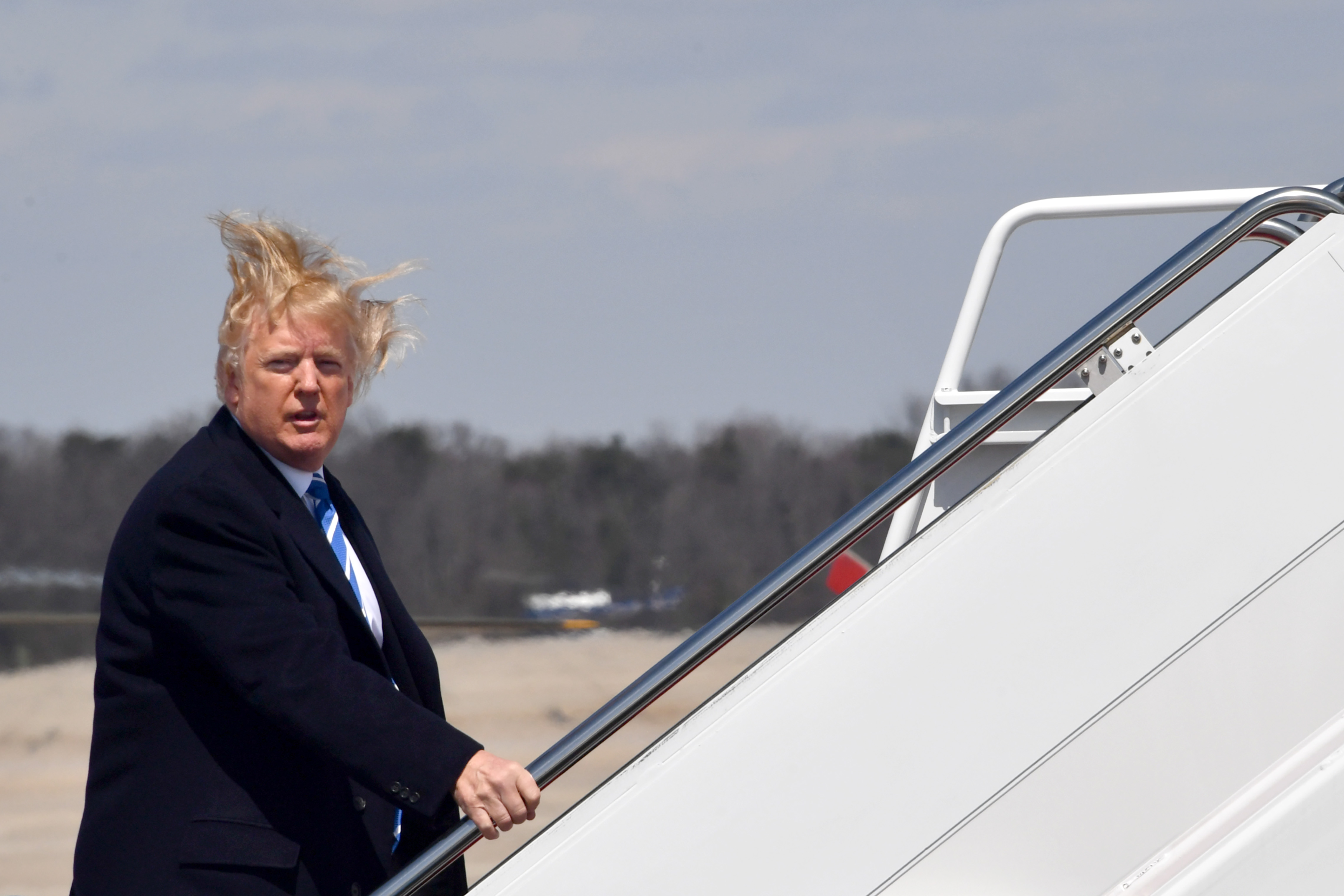 US President Donald Trump boards Air Force One on a windy day at Andrews Air Force base on April 5, 2018 near Washington, DC. Trump is heading to White Sulphur Springs, West Virginia for a round table discussion on tax reform. (NICHOLAS KAMM/AFP/Getty Images)