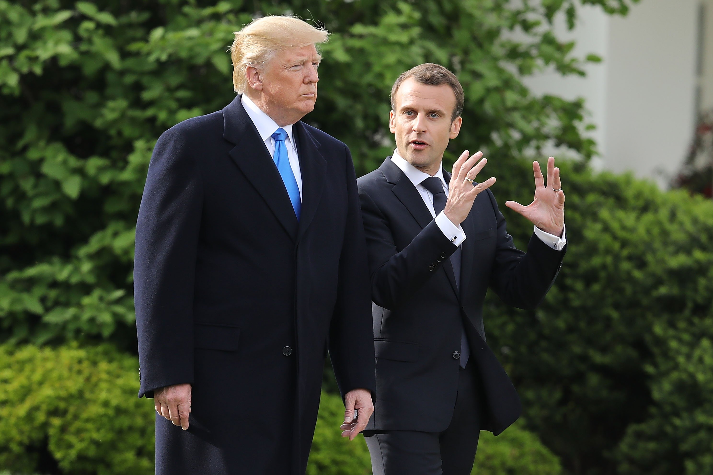 WASHINGTON, DC - APRIL 23: U.S President Donald Trump (L) and French President Emmanuel Macron walk out of the White House before participating in a tree-planting ceremony on the South Lawn April 23, 2018 in Washington, DC. Trump is hosting Macron for a two day offical visit that will include dinner at George Washington's Mount Vernon, a tree planting on the White House South Lawn and a joint news conference. (Photo by Chip Somodevilla/Getty Images)