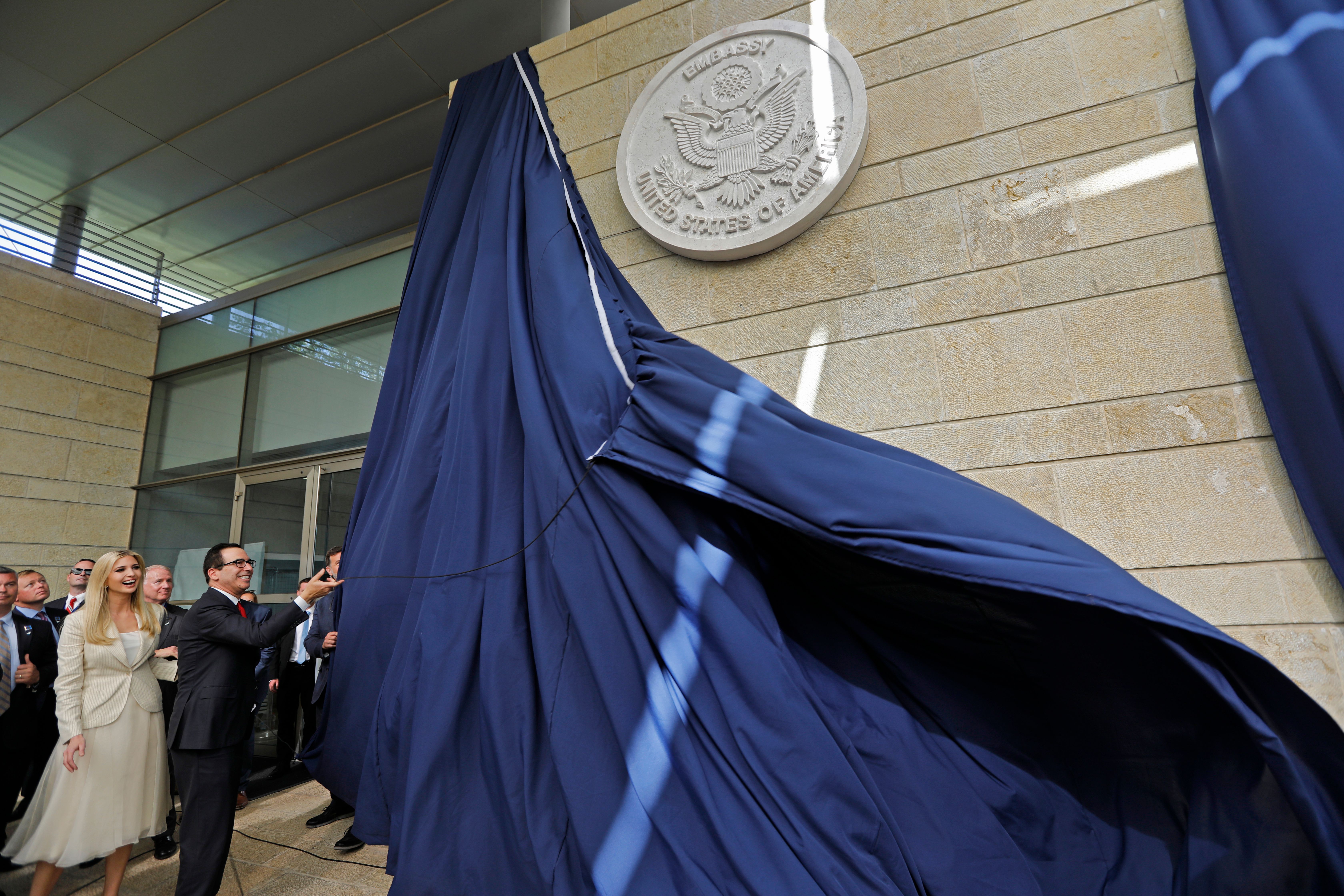 US Treasury Secretary Steve Mnuchin and US President's daughter Ivanka Trump unveil an inauguration plaque during the opening of the US embassy in Jerusalem on May 14, 2018. - The United States moved its embassy in Israel to Jerusalem after months of global outcry, Palestinian anger and exuberant praise from Israelis over President Donald Trump's decision tossing aside decades of precedent. (Photo by Menahem KAHANA / AFP) (Photo credit should read MENAHEM KAHANA/AFP/Getty Images)