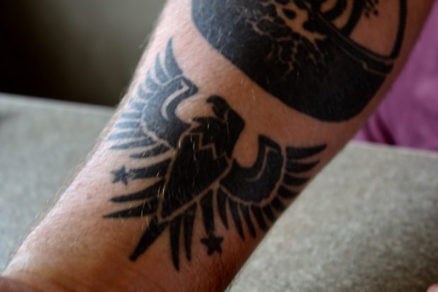 The tattoo on Neimann's right arm represents Marines he met on a trip to Jamaica, as well as both of his granfathers who served in the military. (Julia Nista/The Daily Caller)