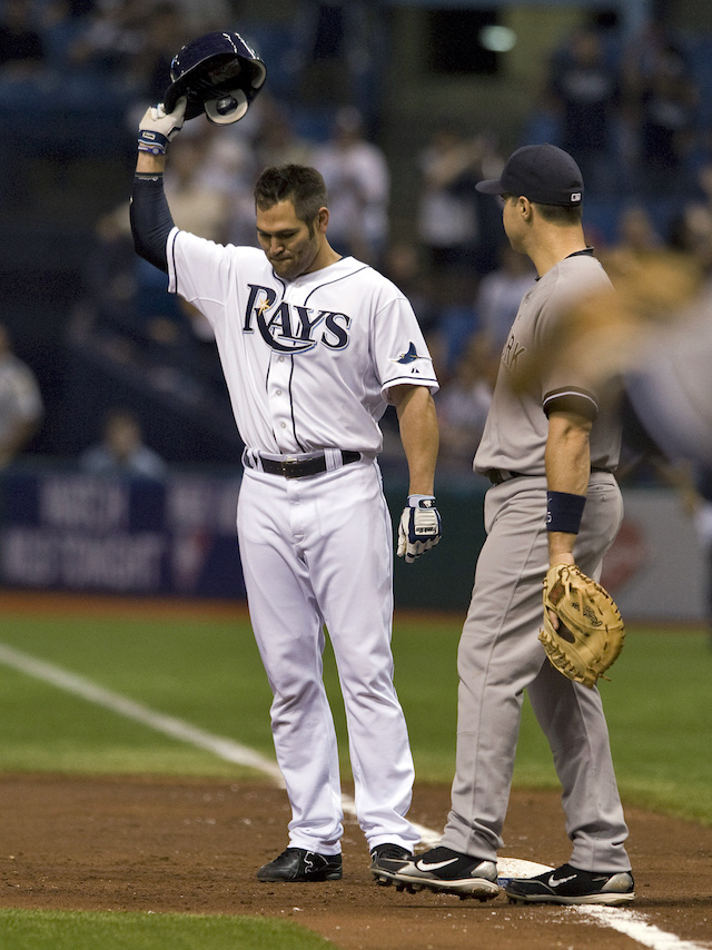 New York Yankees' Mark Teixeira looks on as Tampa Bay Rays' Johnny Damon (L) tips his hat to the fans after hitting a single to pass Lou Gehrig on the all-time hit list during the second inning of their American League MLB baseball game in St. Petersburg, Florida September 27, 2011. REUTERS/Steve Nesius (UNITED STATES - Tags: SPORT BASEBALL) - GM1E79S0P7H01