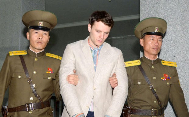 FILE PHOTO - Otto Frederick Warmbier (C), a University of Virginia student who was detained in North Korea since early January, is taken to North Korea's top court in Pyongyang, North Korea, in this photo released by Kyodo March 16, 2016. Mandatory credit REUTERS/Kyodo/File Photo