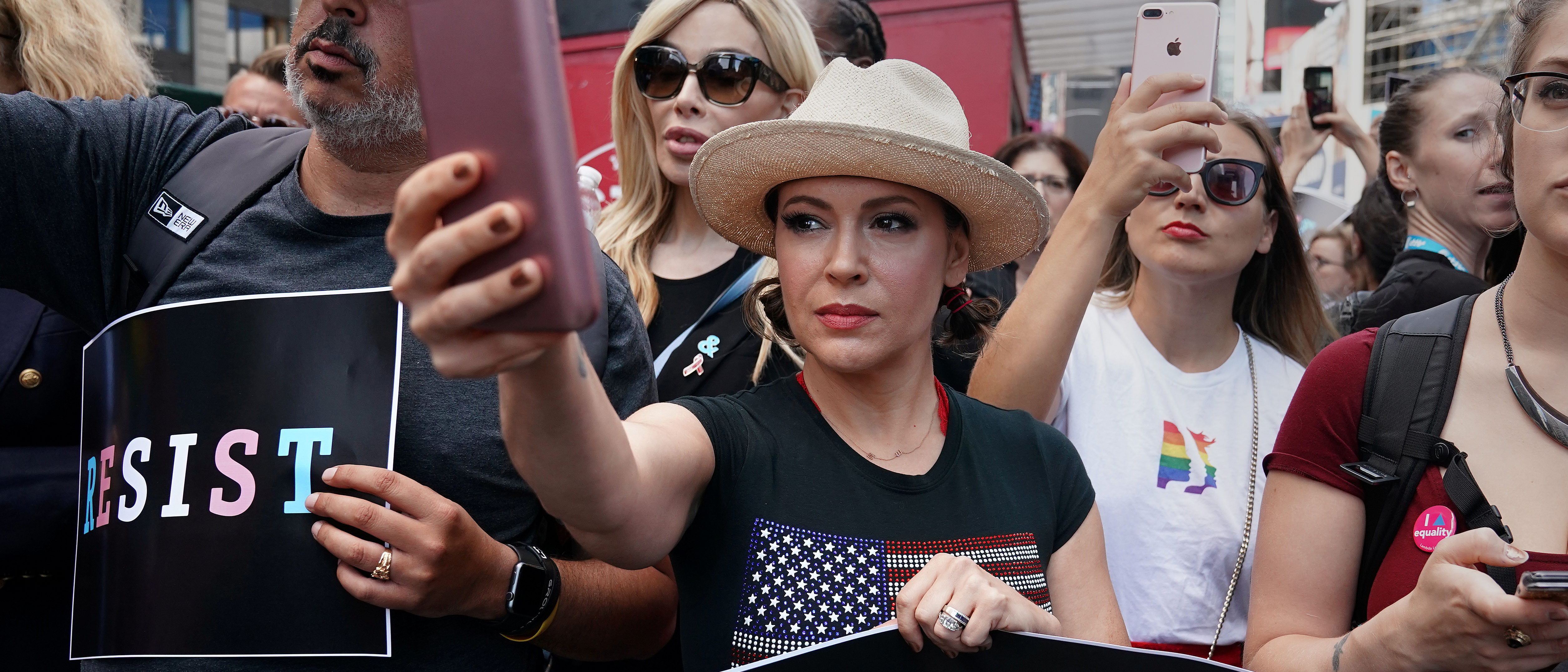 Actress Alyssa Milano attends a protest against U.S. President Donald Trump's announcement that he plans to reinstate a ban on transgender individuals from serving in any capacity in the U.S. military, in Times Square, in New York City, New York, U.S., July 26, 2017. REUTERS/Carlo Allegri - RC1BA409A7E0