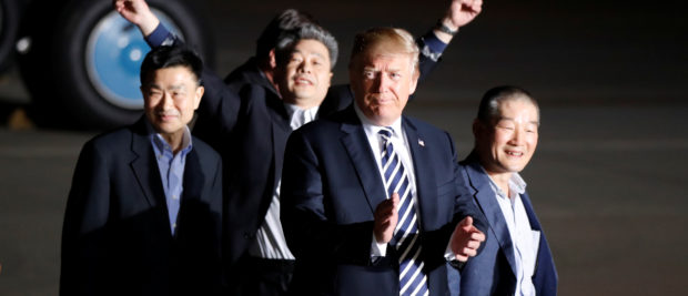 The three Americans formerly held hostage in North Korea gesture next to U.S.President Donald Trump, upon their arrival at Joint Base Andrews, Maryland, U.S., May 10, 2018. REUTERS/Jim Bourg - RC1FDB2A7BD0