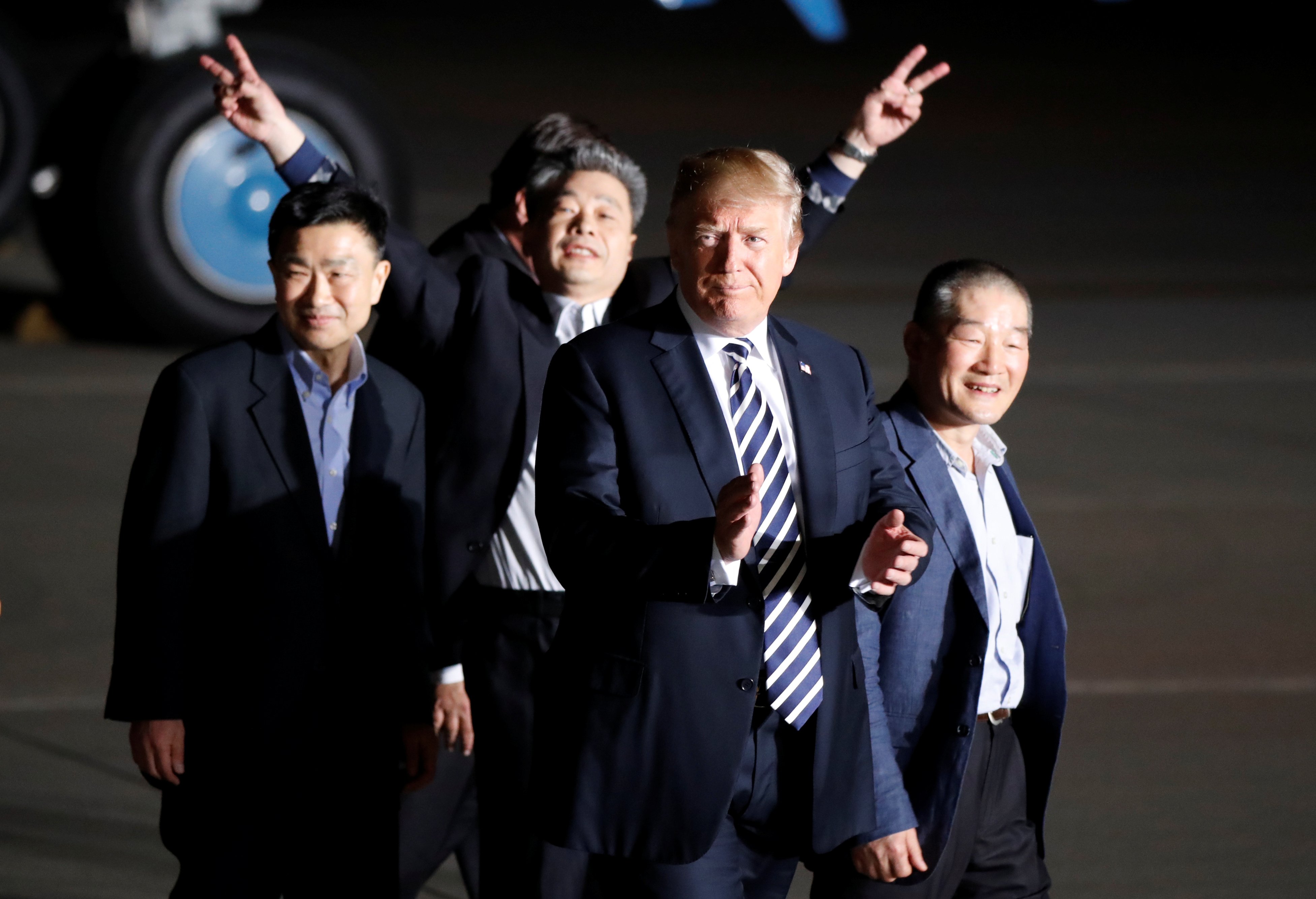 The three Americans formerly held hostage in North Korea gesture next to U.S.President Donald Trump, upon their arrival at Joint Base Andrews, Maryland, U.S., May 10, 2018. REUTERS/Jim Bourg - RC1FDB2A7BD0
