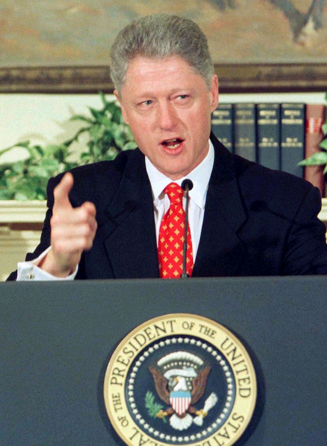 Former President Bill Clinton denies allegations of a sexual relationship with former White House intern Monica Lewinsky during a White House event unveiling new child care proposals in this January 26, 1998 file photo. REUTERS/Win Mcnamee/File Photo
