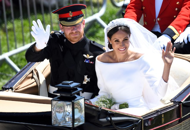 Britain's Prince Harry, Duke of Sussex and his wife Meghan, Duchess of Sussex wave from the Ascot Landau Carriage during their carriage procession on the Long Walk as they head back towards Windsor Castle in Windsor, on May 19, 2018 after their wedding ceremony. (Photo by Emmanuel DUNAND / AFP) (Photo credit should read EMMANUEL DUNAND/AFP/Getty Images)