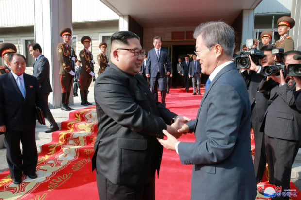South Korean President Moon Jae-in shakes hands with North Korean leader Kim Jong Un during their summit at the truce village of Panmunjom, North Korea, in this handout picture released by North Korea's Korean Central News Agency (KCNA) on May 27, 2018. KCNA/via REUTERS 