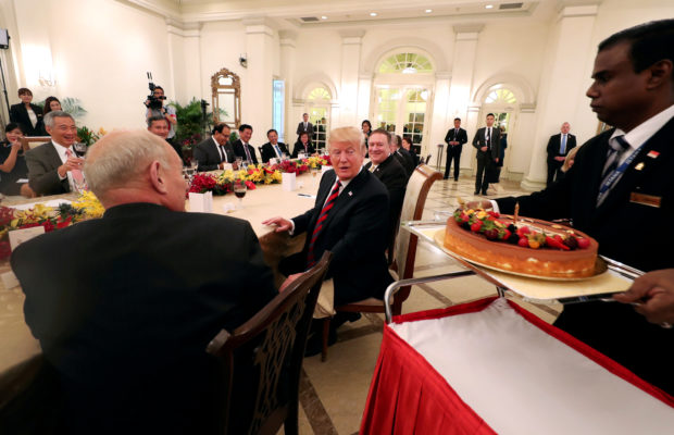 U.S. President Donald Trump is presented with a birthday cake as he attends a lunch with Singapore's Prime Minister Lee Hsien Loong at the Istana in Singapore June 11, 2018. Mandatory credit Ministry of Communications and Information, Singapore/Handout via REUTERS