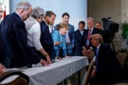 Canada's Prime Minister Justin Trudeau and G7 leaders Britain's Prime Minister Theresa May, France's President Emmanuel Macron, Germany's Chancellor Angela Merkel, and U.S. President Donald Trump discuss the joint communique following a breakfast meeting on the second day of the G7 meeting in Charlevoix city of La Malbaie, Quebec, Canada, June 9, 2018. Adam Scotti/Prime Minister's Office/Handout via REUTERS. ATTENTION EDITORS - THIS IMAGE WAS PROVIDED BY A THIRD PARTY. - RC1BCA7B7B00