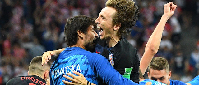 Croatia's midfielder Luka Modric (top C) celebrates with teammates after Croatia won the penalty shoot-out at the end of the Russia 2018 World Cup round of 16 football match between Croatia and Denmark at the Nizhny Novgorod Stadium in Nizhny Novgorod on July 1, 2018. (Photo credit: JOHANNES EISELE/AFP/Getty Images)
